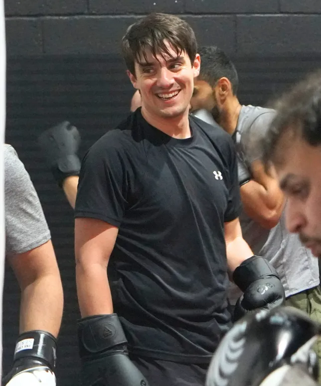 Adult member smiling with boxing gloves at Limitless adults martial arts class in Southampton